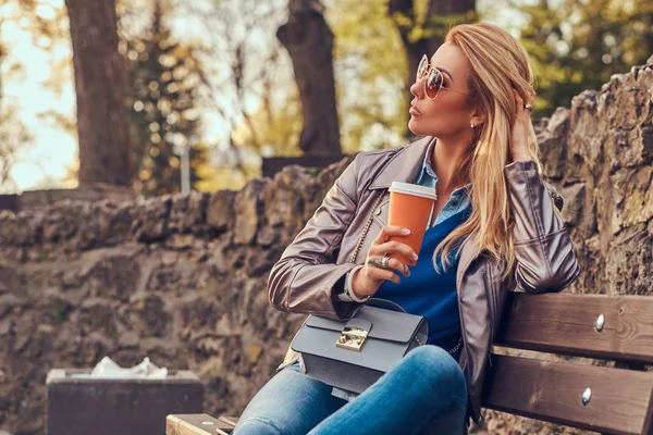 Modieuze Blonde Vrouw Ontspant Outdoor Drinken Afhaalmaaltijden Koffie Zittend Bank — Stockfoto