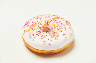 Beyaz arka plan üzerinde izole sprinkles ile iştah açıcı beyaz çörek.