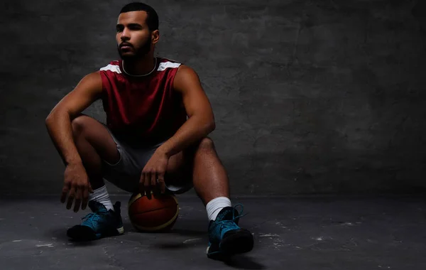 Young African American Basketball Player Sportswear Sitting Ball Isolated Dark — Stock Photo, Image