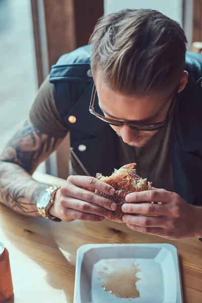 Close Portrait Hungry Hipster Guy Stylish Haircut Beard Sits Table — Stock Photo, Image