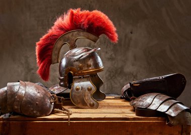 Complete combat equipment of the ancient Greek warrior lie on a box of wooden boards. clipart