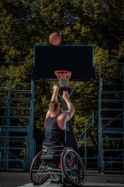 Tekerlekli sandalyede kötürüm basketbol oyuncusu bir açık oyun yere çalış.