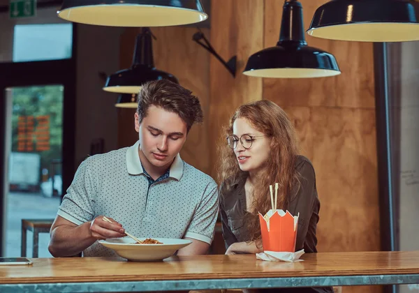 Baharatlı Erişte Asya bir restoranda yemek giyiyor rahat kıyafetler genç çekici çift. 