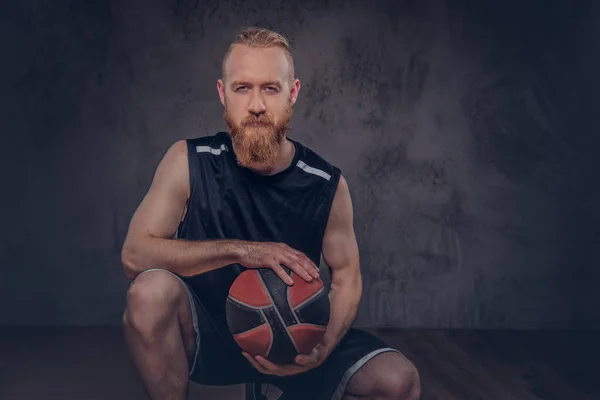 一个红发篮球运动员的肖像在一个黑色的运动装球 孤立的深色纹理背景 — 图库照片