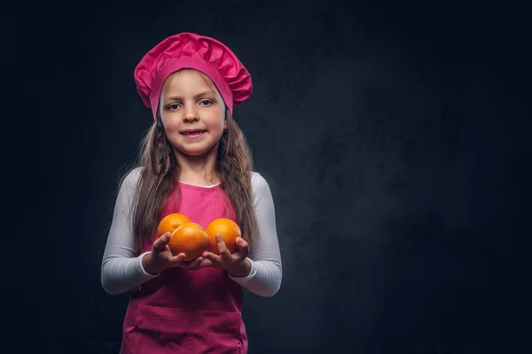 Cute Beautiful Schoolgirl Dressed Pink Cook Uniform Holds Oranges Studio — Stock Photo, Image