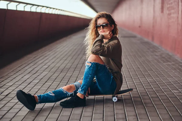 Portrait Pensive Girl Sunglasses Dressed Hoodie Ripped Jeans Sitting Skateboard — Stock Photo, Image