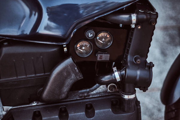 Close-up photo of a custom-made retro motorcycle fuel tank with sensors.