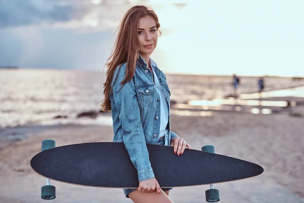 Sensuele Brunette Meisje Gekleed Denim Broek Jas Houdt Skateboard Terwijl — Stockfoto
