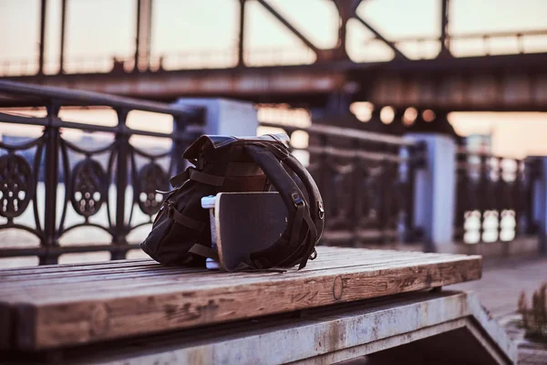 Foto Cerca Una Mochila Monopatín Que Encuentran Banco Terraplén Durante — Foto de Stock