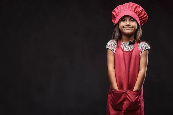 Cute Little Girl Dressed Pink Cook Uniform Holds Arms Pockets — Stock Photo, Image