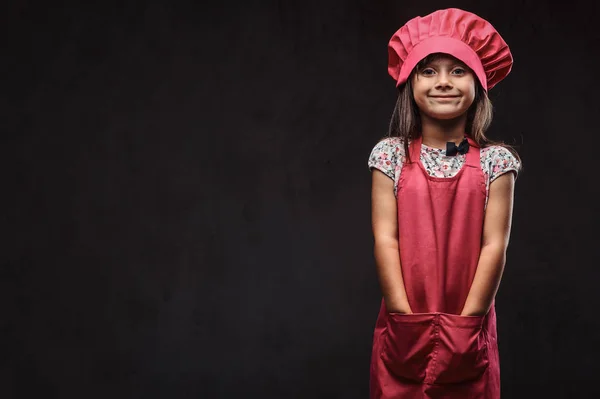 Linda Niña Vestida Con Uniforme Cocinero Rosa Sostiene Los Brazos —  Fotos de Stock