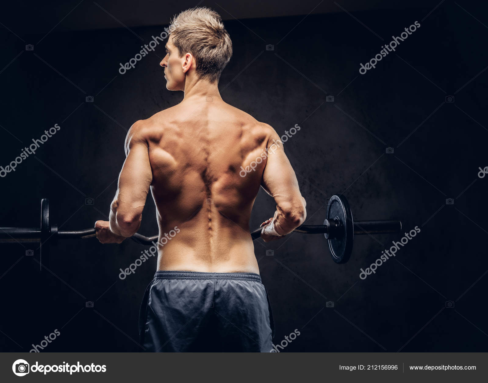 Back View Shirtless Man Stylish Hair Muscular Ectomorph Doing Exercises Stock Photo fxquadro 212156996
