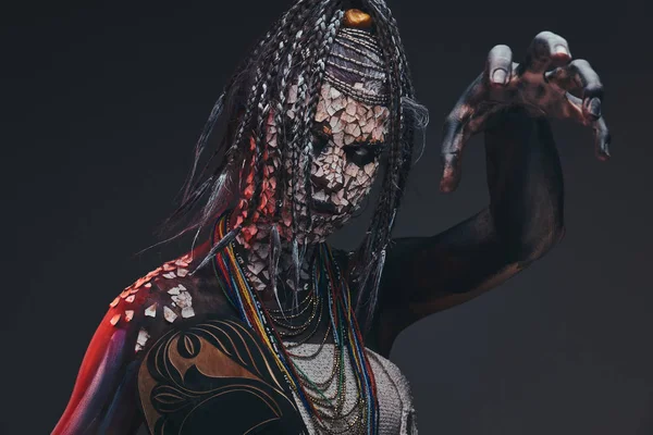 Scary African shaman with a petrified cracked skin and dreadlocks. Make-up concept. — Stock Photo, Image