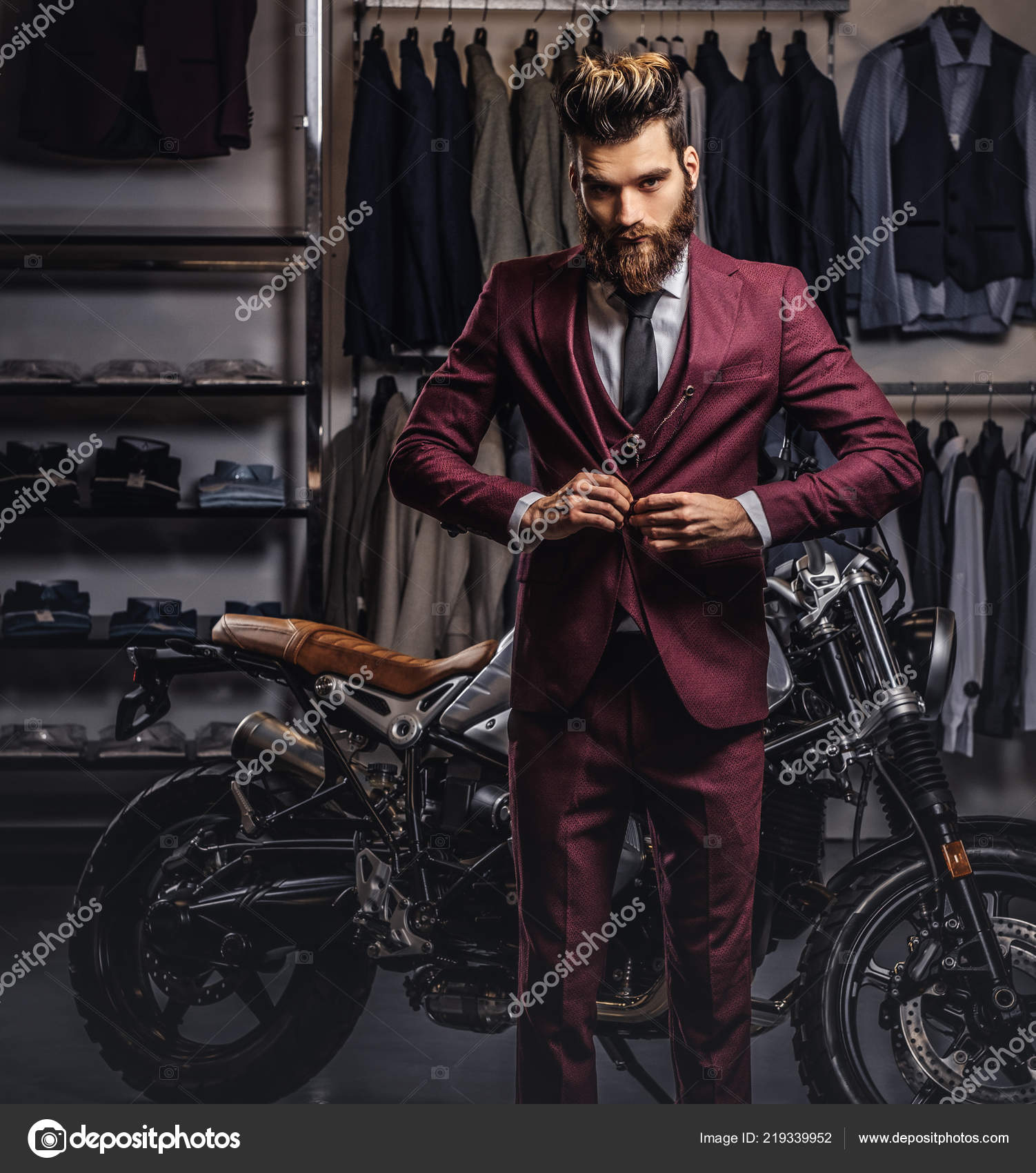 Handsome man with a stylish beard and hair dressed in vintage red suit posing near retro sports motorbike at mens clothing store. Stock Photo by ©fxquadro 219339952 Handsome man with a stylish beard and hair dressed in vintage red suit posing near retro sports motorbike at mens clothing store. Stock Photo by ©fxquadro 219339952