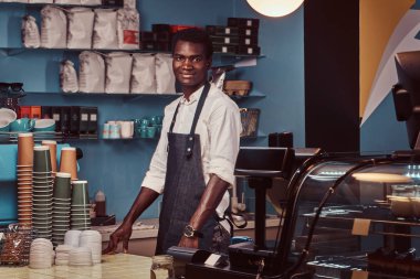Yakışıklı bir Afrika barista trendy coffee shop kontuarında portresi.
