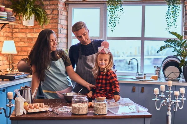 Adorable family together cooking breakfast in loft style kitchen.