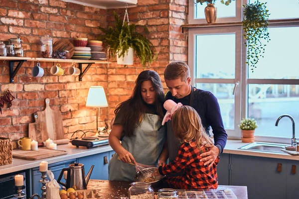 Adorable family together cooking breakfast in loft style kitchen.