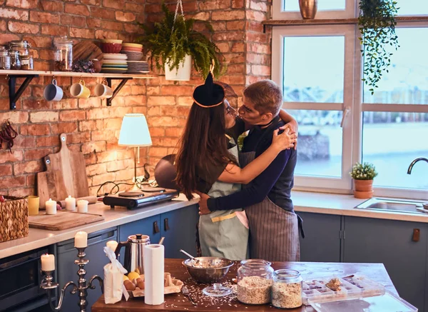 Stilig hane kyssa sin fru i loft stil kök i morgon. — Stockfoto