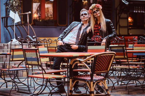 Young attractive couple with undead posing near mexican restaurant outdoors. — Stock Photo, Image