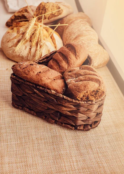 Freshly bakery products and spikelets on cloth at home. — Stock Photo, Image