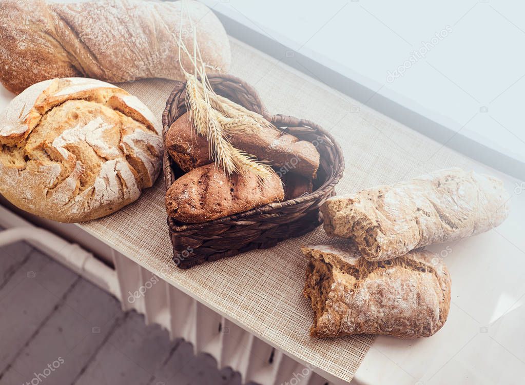 Freshly bakery products and spikelets on cloth at home. 