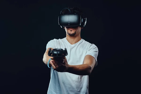 Man with bristle dressed in white shirt playing games with virtual reality goggle . — Stok Foto