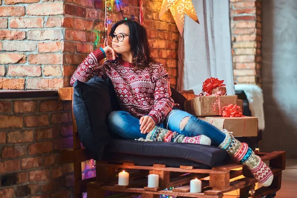 Noel sabahı ise bir kanepede oturan ve çatı iç ile dekore edilmiş bir odada pencere bakarak zevk güzel kız.