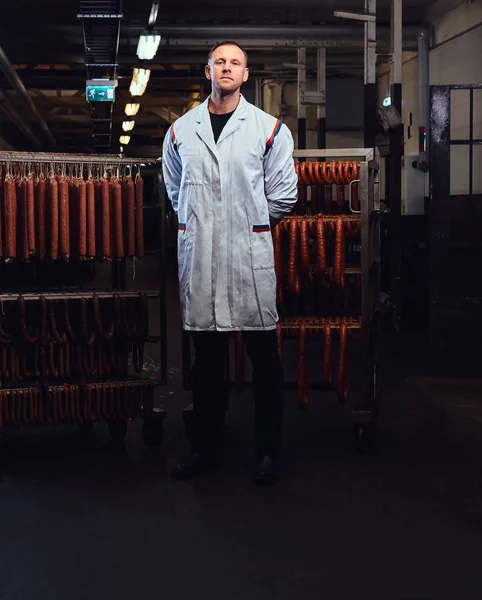 Professional butcher standing in the storage room. — Stock Photo, Image