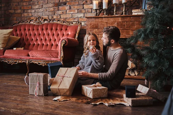 Love, family, fatherhood, Christmastime. Happiness father and his cute little daughter sitting on the floor surrounded by gifts — Stock Photo, Image