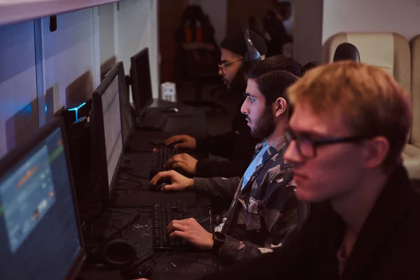 Team of teenage gamers plays in a multiplayer video game on pc in a gaming club. — Stock Photo, Image