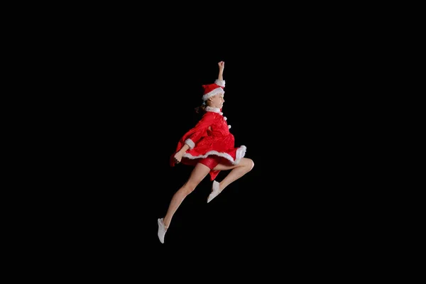 クリスマスの時、子供の頃、おとぎ話。サンタの衣装を着て若い女の子が飛んでください。 — ストック写真