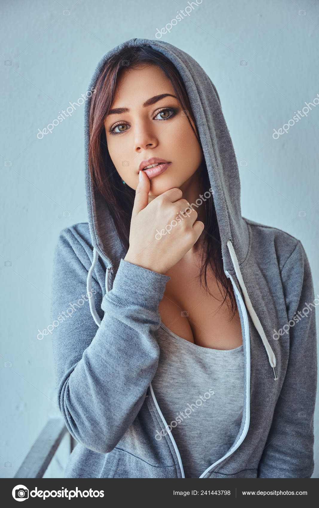 Slim woman looking at camera and holding hand to hand Stock Photo by  fxquadro