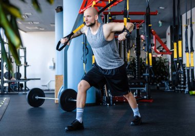 Süspansiyon fitness halat boyu spor salonunda egzersiz sakallı atletik erkek