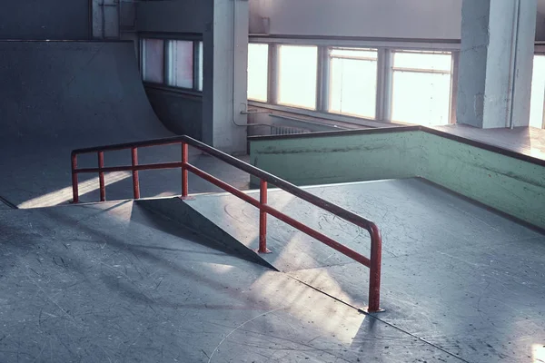 Skateboard railing for grinding at the empty indoors skatepark