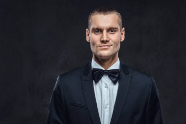 Yakışıklı şık giyen zarif klasik takım elbise bir papyon ile portresi.