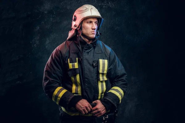 Manly firefighter in helmet looks sideways — Stock Photo, Image