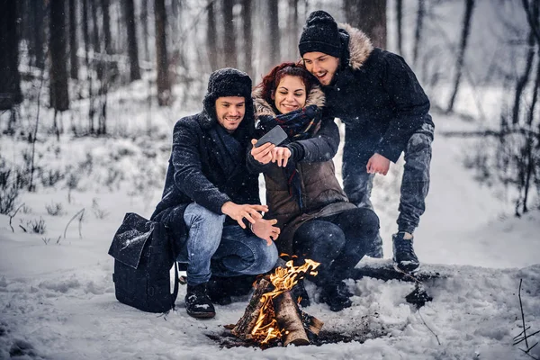 Friends doing selfies near the campfire — Stock Photo, Image