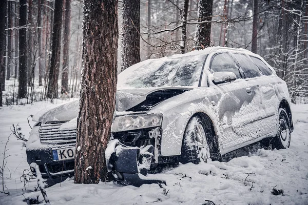 Bilen hamnade i en skid och kraschade in i ett träd på en snöig väg. — Stockfoto