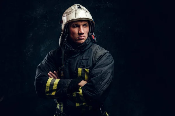 Manly firefighter in helmet looks sideways — Stock Photo, Image