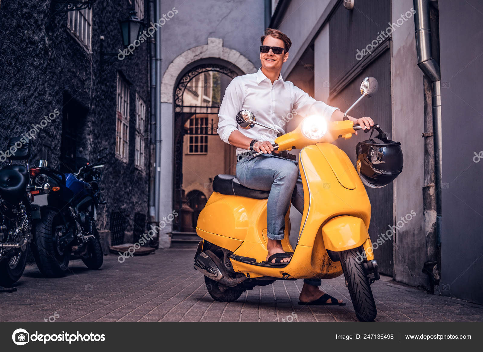 Premium Photo | Carefree ride. top view of handsome young man in sunglasses  riding scooter along the street and smiling