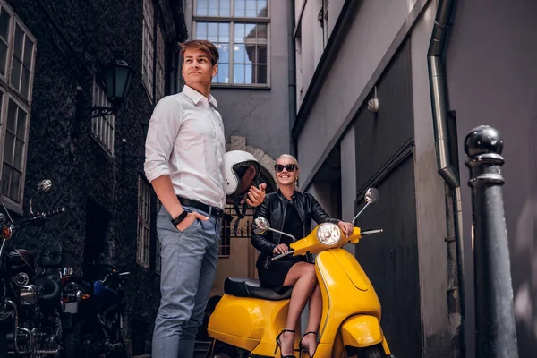 Молодая романтическая пара позирует с ретро итальянский скутер на старой узкой улице — стоковое фото