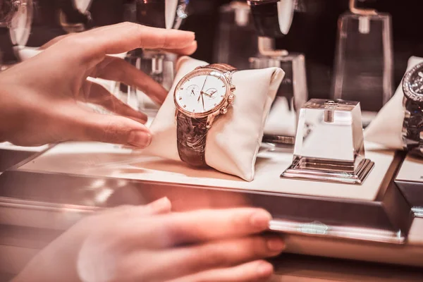 Close-up of the sellers hand shows the exclusive mens watch from the new collection