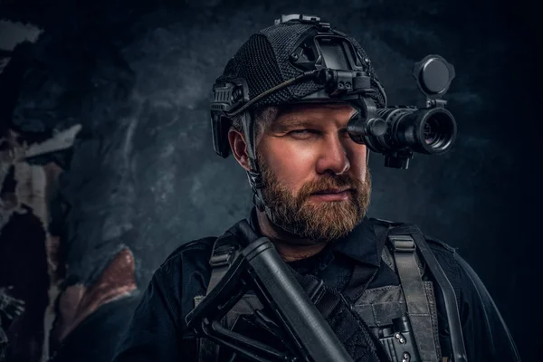 Close-up portrait of a bearded special forces soldier observes the surroundings in night vision goggles. — Stock Photo, Image
