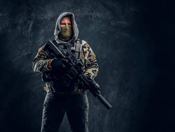 Specialstyrkor soldat i militär uniform bär mask och huva som håller en automatkarbin. — Stockfoto