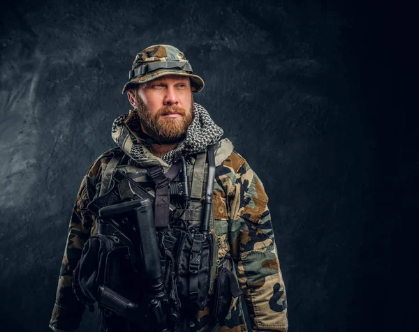 Portrait of a special forces soldier in the military camouflaged uniform, looking sideways. — Stock Photo, Image