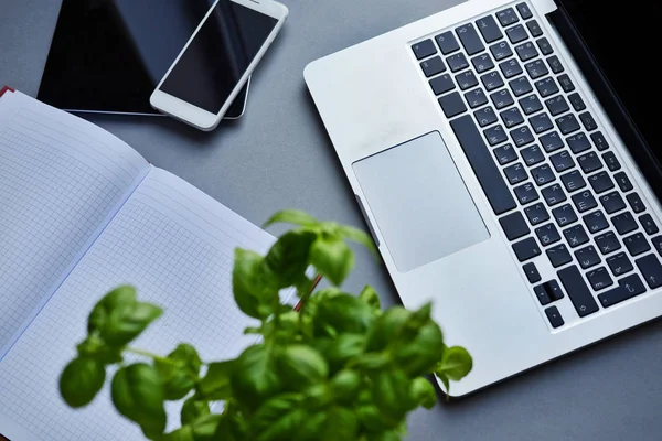 Laptop, tablet, smartphone and notebook on a table in the office — Stock Photo, Image