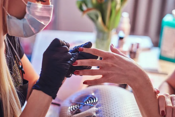 Cuidado de uñas y manicura. Una mujer en un salón de belleza. De cerca las manos —  Fotos de Stock