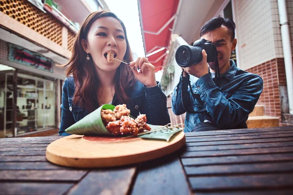 Young asian couple enjoy chinese food and photo shooting