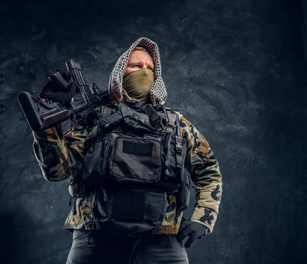 Ειδικές δυνάμεις στρατιώτης με στρατιωτική στολή που φορούσε μάσκα και καπό ποζάρει με ένα τουφέκι επιθέσεων. — Φωτογραφία Αρχείου