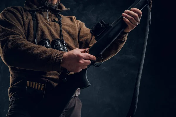Closeup on hands. Opening of the spring hunting season. Hunter ready to hunt and charging a hunting rifle — Stock Photo, Image